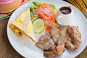 Beef steak with black pepper sauce , salad and French fries on s