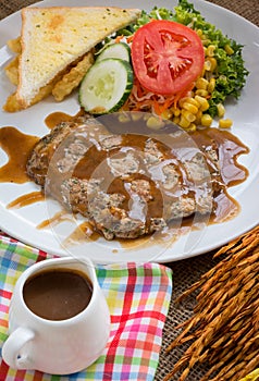 Beef steak with black pepper sauce , salad and French fries on s