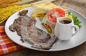 Beef steak with black pepper sauce , salad and French fries on s