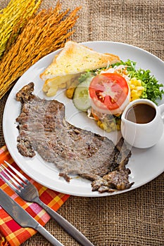 Beef steak with black pepper sauce , salad and French fries on s