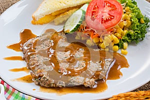 Beef steak with black pepper sauce , salad and French fries on s