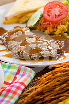 Beef steak with black pepper sauce , salad and French fries on s