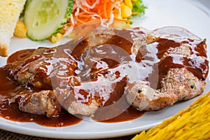 Beef steak with black pepper sauce , salad and French fries on s