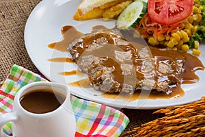 Beef steak with black pepper sauce , salad and French fries on s