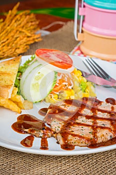 Beef steak with black pepper sauce , salad and French fries on s