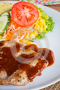 Beef steak with black pepper sauce , salad and French fries on s