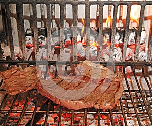 Beef steak cooked rare in a fireplace