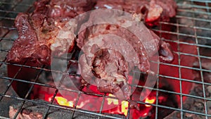 Beef steak cooking over flaming grill