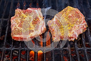 beef steak cooking over flaming grill