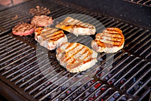 Beef steak cooking over flaming grill.grilled meat skewers, barbecue.Delicious cooked meat. summer season. garden party