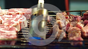 Beef steak dice cooking and flamed on bbq grill oven. Street food vendor in Taiwan