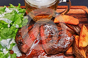 Beef steak with french fries and beer