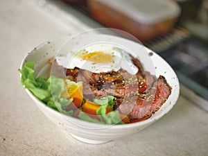 Beef steak with a fried egg, rice nd vegetables