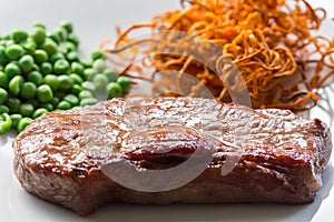 Beef steak with green peas and sweet potato