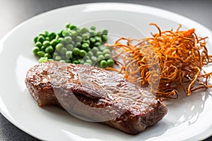 Beef steak with green peas and sweet potato