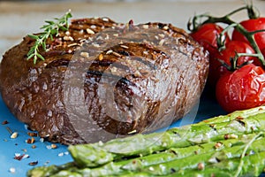 Beef steak grilled with asparagus, tomatoes, spice