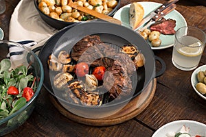 Beef steak grilled with grilled vegetables, salad and potatoes