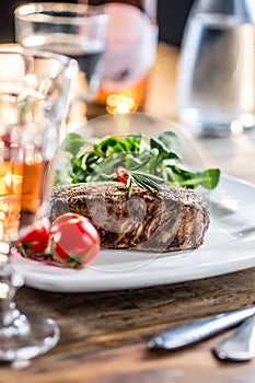 Beef Steak. Juicy beef steak. Gourmet steak with vegetables and glass of rose wine on wooden table