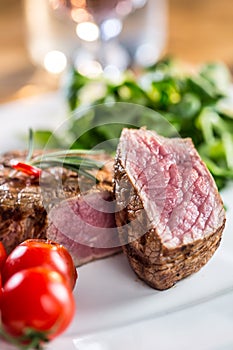 Beef Steak. Juicy beef steak. Gourmet steak with vegetables and glass of rose wine on wooden table