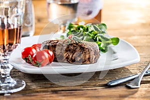 Beef Steak. Juicy beef steak. Gourmet steak with vegetables and glass of rose wine on wooden table