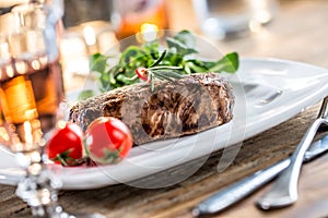 Beef Steak. Juicy beef steak. Gourmet steak with vegetables and glass of rose wine on wooden table