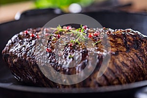 Beef steak. Juicy Rib Eye steak in pan on wooden board with herb and pepper