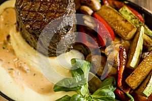 Beef steak with mashed potatoes and grilled vegetables