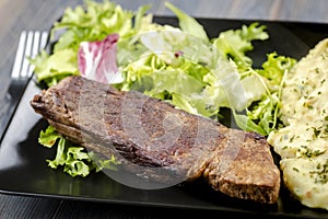 Beef steak with mashed potatoes and rocket salad