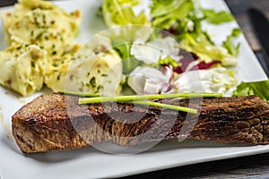 Beef steak with mashed potatoes and rocket salad