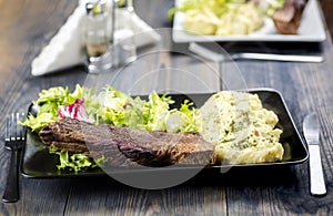 Beef steak with mashed potatoes and rocket salad