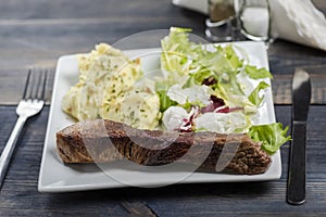 Beef steak with mashed potatoes and rocket salad