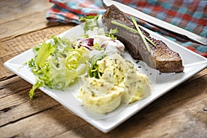 Beef steak with mashed potatoes and rocket salad