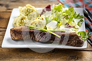 Beef steak with mashed potatoes and rocket salad