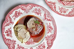 Beef steak with mashed potatoes in sauce on a beautiful porcelain plate