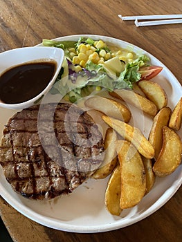Beef steak with perfect doneness served with sliced ??vegetables and potatoes