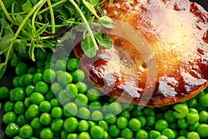 Beef steak pies with rich onion gravy served with sweet peas and salad