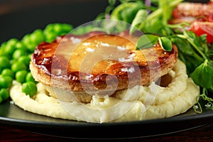 Beef steak pies with rich onion gravy served with sweet peas and salad