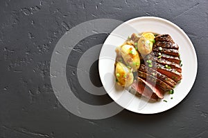 Beef steak with potato and caramelized onion