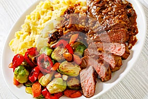 Beef steak with potato mash and roasted vegetables