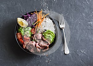 Beef steak, rice and vegetable power bowl. Healthy balanced food concept. On a dark background