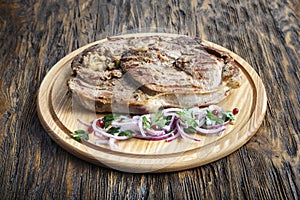 Beef steak on a round cutting board