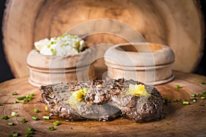 Beef steak served with mashed potato and gravy with melting butter