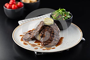 A beef steak served with salad