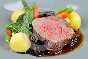 Beef steak with sesonal vegetables close up.