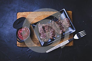 Rolled beef steak with tomato sauce on cutting wood photo