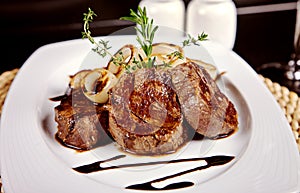 Beef steak with soy sauce, rosemary and onion