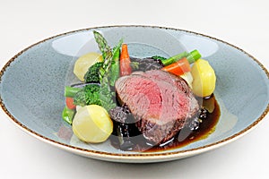 Beef steak with sesonal vegetables close up.