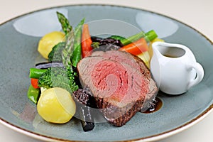 Beef steak with sesonal vegetables close up.