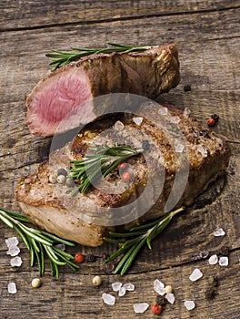 Beef steak on a wooden table.