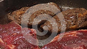 Beef steaks are cooking in the pan